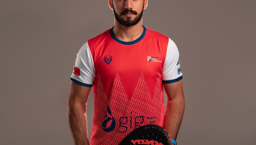 Man in Red and White Shirt Holding Red and Black Padel